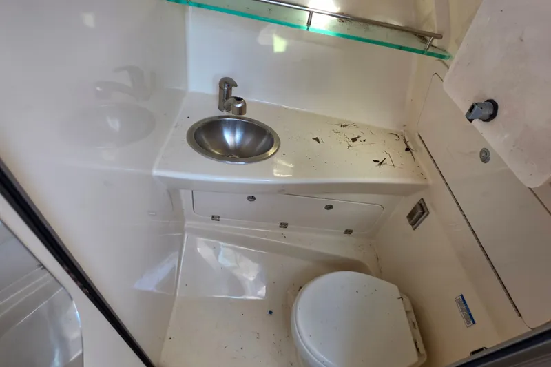 Slide: The Image of 2012 Boston Whaler 285 Conquest boat bathroom with sink and toilet. - 15