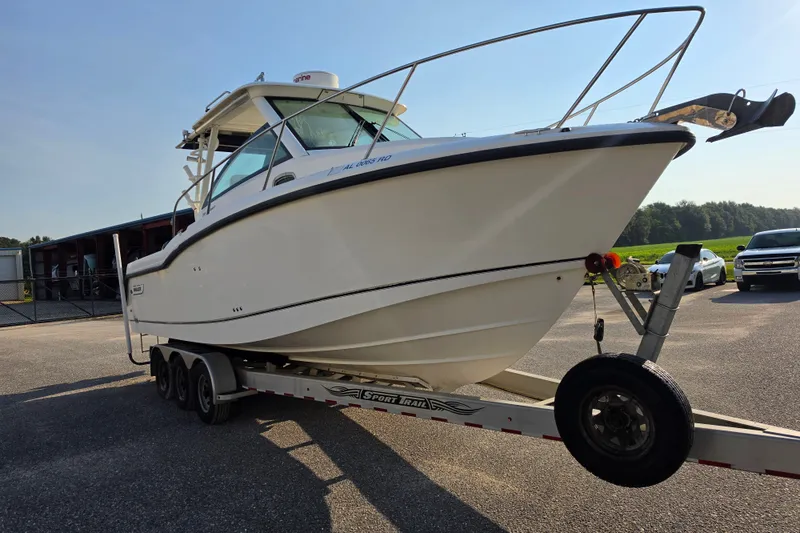 Slide: The Image of 2012 Boston Whaler 285 Conquest boat on trailer in parking lot. - 5
