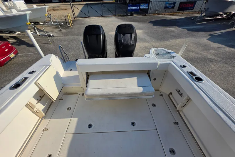 Slide: The Image of 2012 Boston Whaler 285 Conquest boat deck with seating and storage compartments. - 14