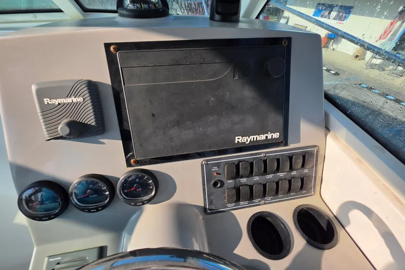 Slide: The Image of Control panel of 2012 Boston Whaler 285 Conquest with Raymarine electronics and gauges. - 12