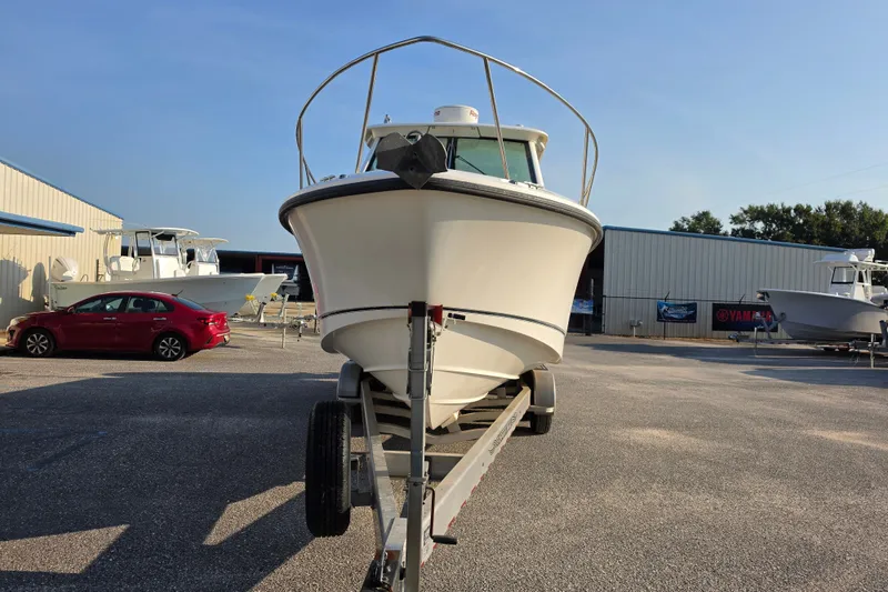 Slide: The Image of 2012 Boston Whaler 285 Conquest boat on trailer in marina parking lot. - 4