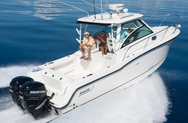 The Image of Manufacturer Provided Image: 2012 Boston Whaler 285 Conquest boat cruising on water with twin Mercury engines. - 20