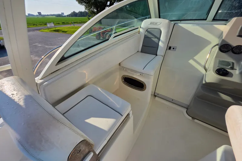 Slide: The Image of Interior of a 2012 Boston Whaler 285 Conquest boat, featuring seating and dashboard. - 10