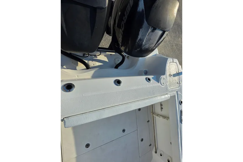 Slide: The Image of 2012 Boston Whaler 285 Conquest boat engine area with dual outboard motors. - 16