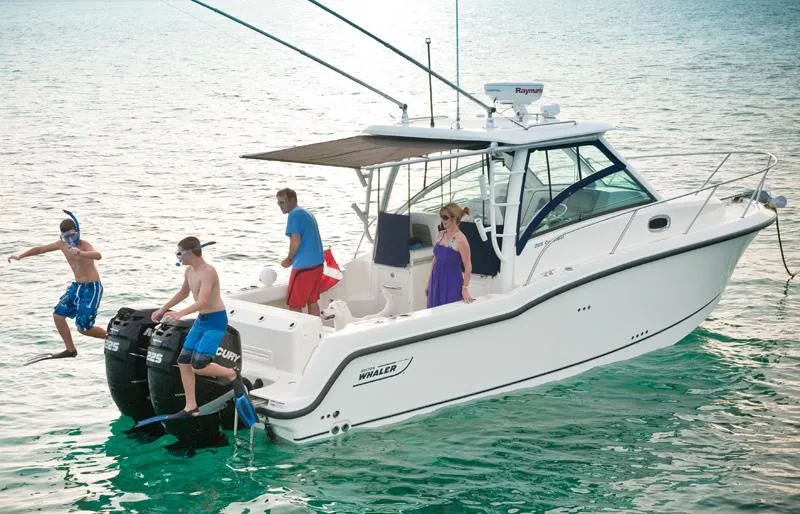 Slide: The Image of Manufacturer Provided Image: 2012 Boston Whaler 285 Conquest boat with people enjoying water activities. - 1