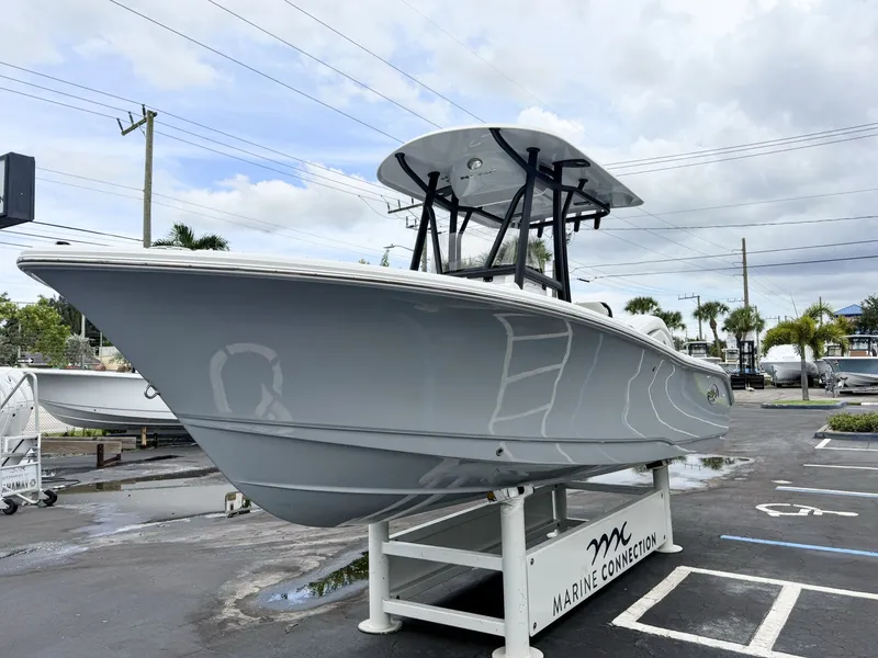 Slide: The Image of A 2027 Sea Hunt Ultra 219 boat is on a stand in a parking lot. - 4