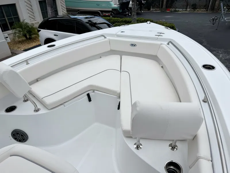 Slide: The Image of The image shows the bow area of a Sea Hunt Ultra 219 boat with white cushioned seating. - 25