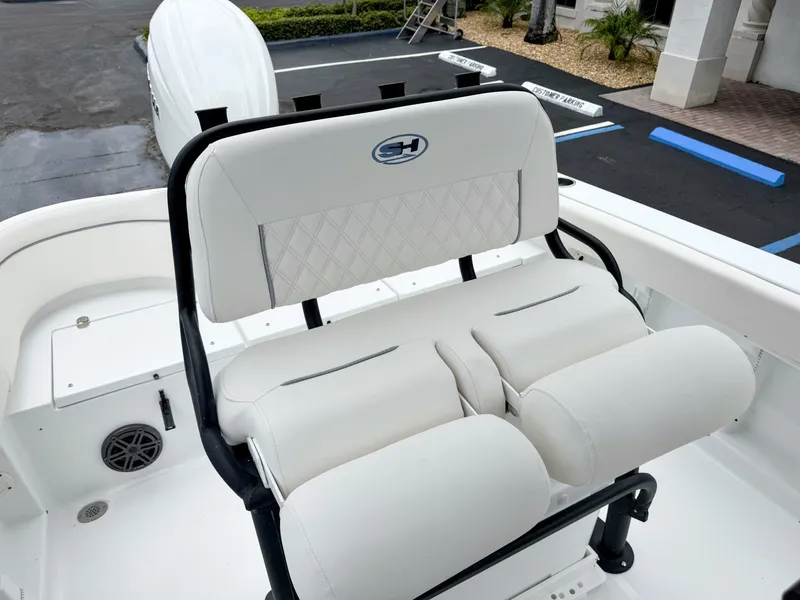 Slide: The Image of The 2027 Sea Hunt Ultra 219 features a cushioned bench seat with white upholstery and a black frame. - 15