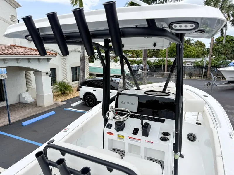 Slide: The Image of The image shows the cockpit of a 2027 Sea Hunt Ultra 219 boat with Garmin equipment. - 13