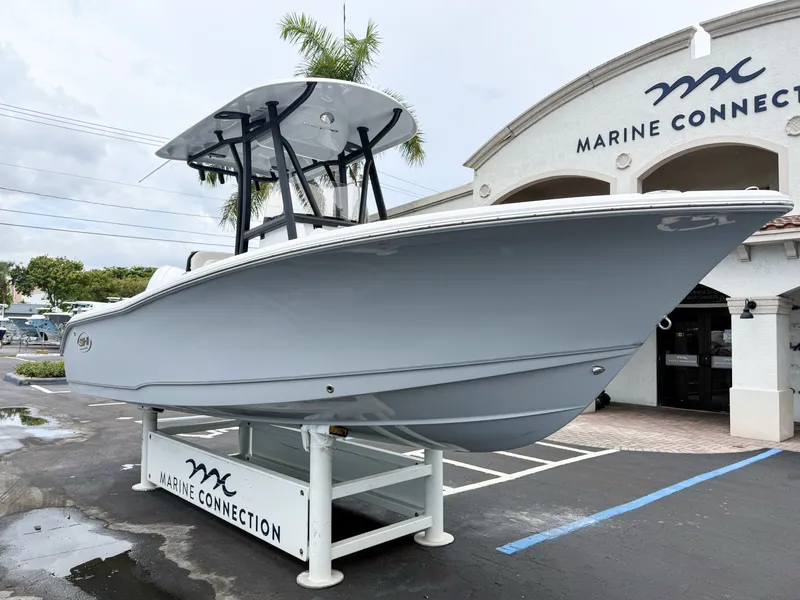 Slide: The Image of A 2027 Sea Hunt Ultra 219 boat is on a stand outside a building labeled "Marine Connection." - 2