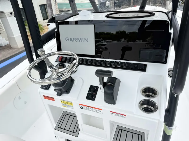 Slide: The Image of The image shows the helm of a Sea Hunt Ultra 219 boat with Garmin navigation. - 16