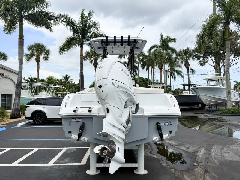 Slide: The Image of A 2027 Sea Hunt Ultra 219 boat is parked, surrounded by palm trees. - 7