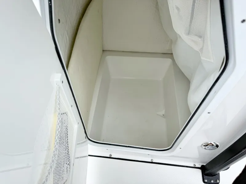 Slide: The Image of Interior view of a boat cabin area with a white floor and mesh storage. - 19