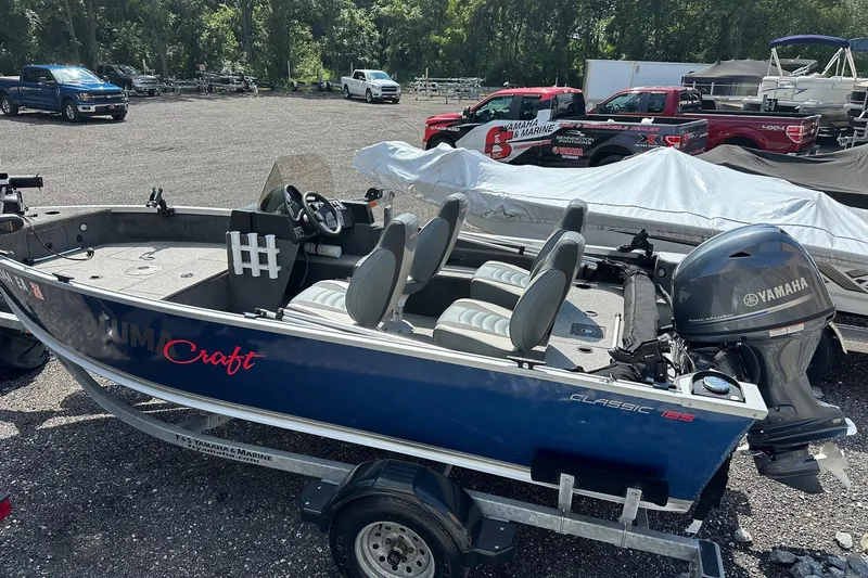 The Image of 2021 Alumacraft Classic 165 CS boat with Yamaha motor in a parking lot. - 1