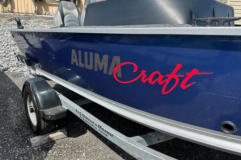 Slide: The Image of 2021 Alumacraft Classic 165 CS boat on trailer, blue exterior with red logo. - 6
