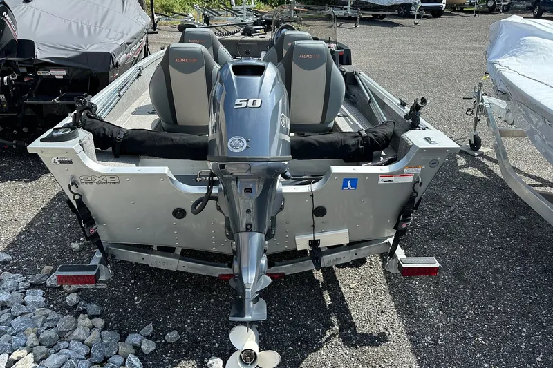 Slide: The Image of 2021 Alumacraft Classic 165 CS boat with Yamaha 50 engine, parked on gravel. - 8