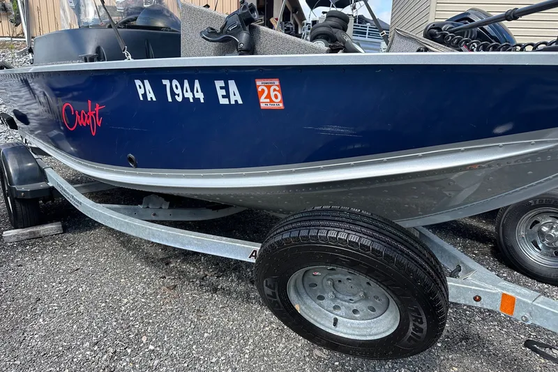 Slide: The Image of 2021 Alumacraft Classic 165 CS boat on trailer, displaying registration number and sticker. - 19