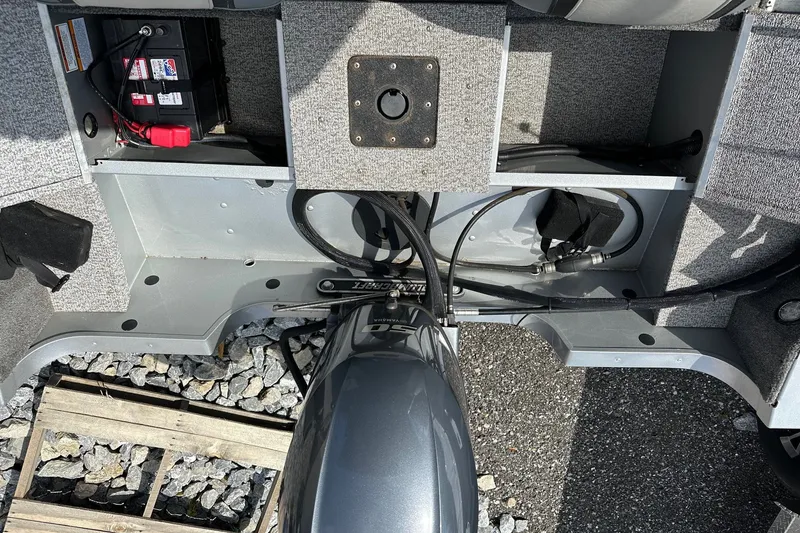 Slide: The Image of 2021 Alumacraft Classic 165 CS boat interior with battery and motor components. - 17