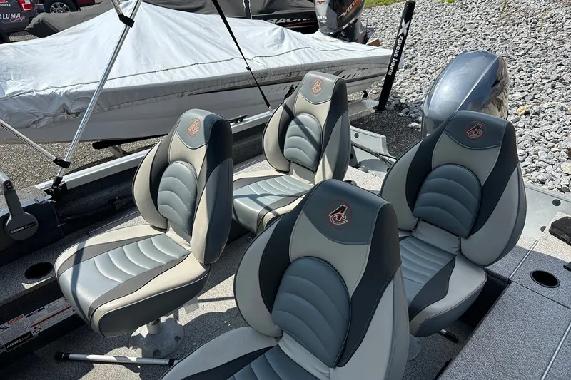 Slide: The Image of 2021 Alumacraft Classic 165 CS boat seats, gray and black, arranged in a row. - 9