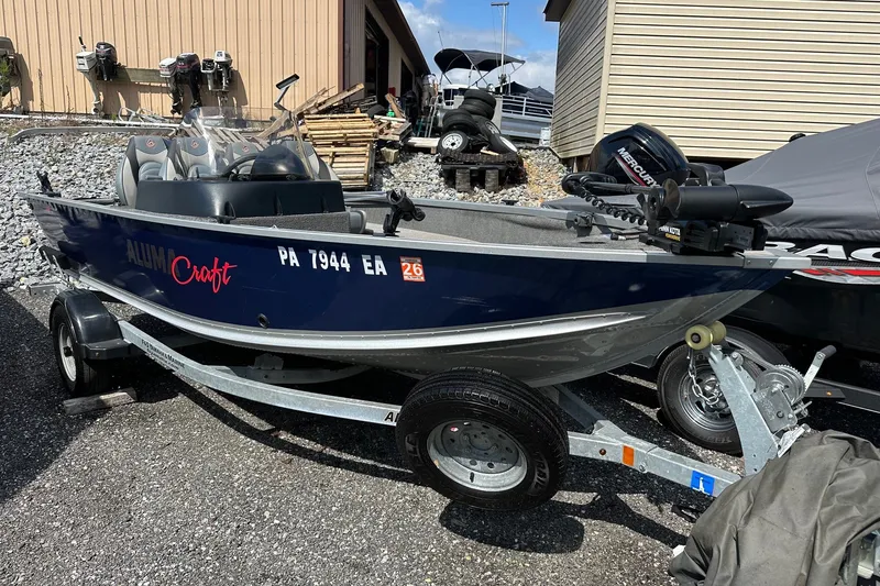 Slide: The Image of 2021 Alumacraft Classic 165 CS boat on trailer, parked outdoors. - 3