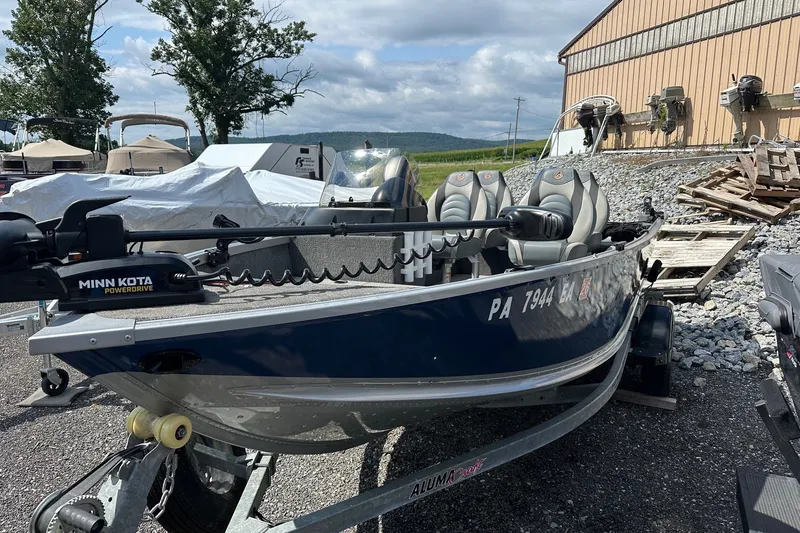 Slide: The Image of 2021 Alumacraft Classic 165 CS boat with Minn Kota PowerDrive motor on trailer. - 2