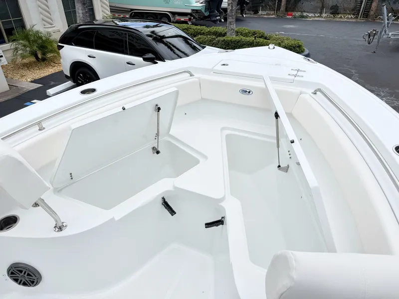 Slide: The Image of The image shows the spacious bow area of a Sea Hunt Ultra 219 boat with storage compartments. - 23
