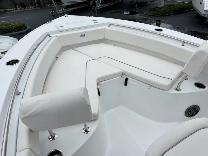 Slide: The Image of The image shows the bow area of a Sea Hunt Ultra 219 boat with white cushions. - 26