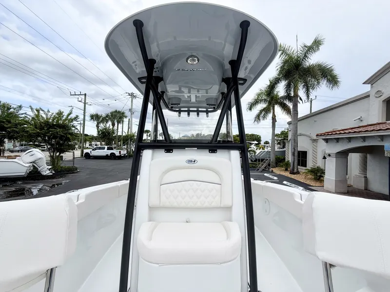 Slide: The Image of The image shows the cockpit of a 2027 Sea Hunt Ultra 219 boat with white seating and a T-top. - 20