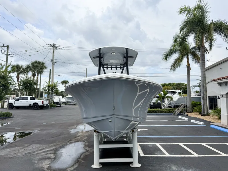 Slide: The Image of A 2027 Sea Hunt Ultra 219 boat on a trailer in a parking lot with palm trees. - 3