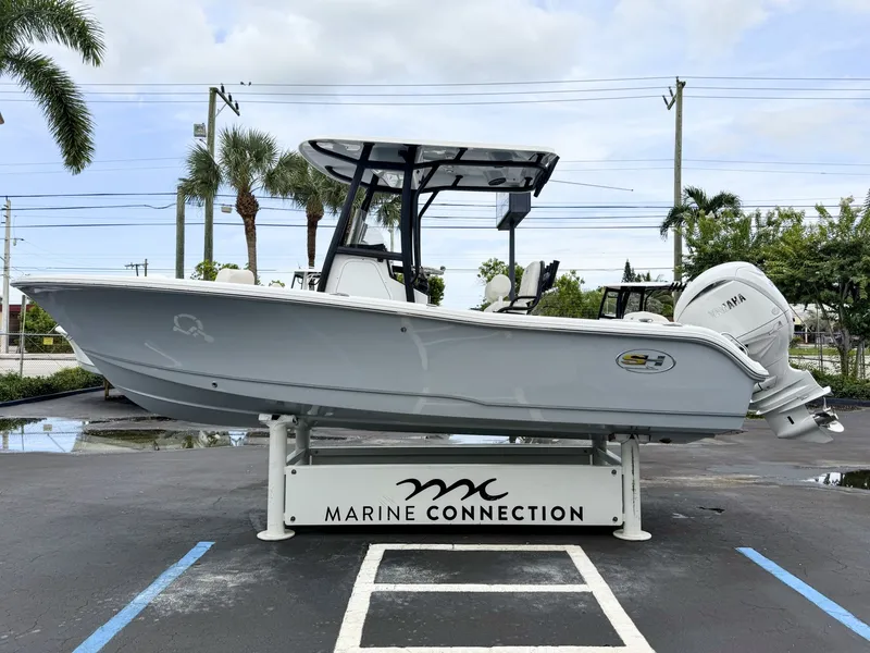 Slide: The Image of Sea Hunt Ultra 219 from 2027 on a parking lot with palm trees in the background. - 5