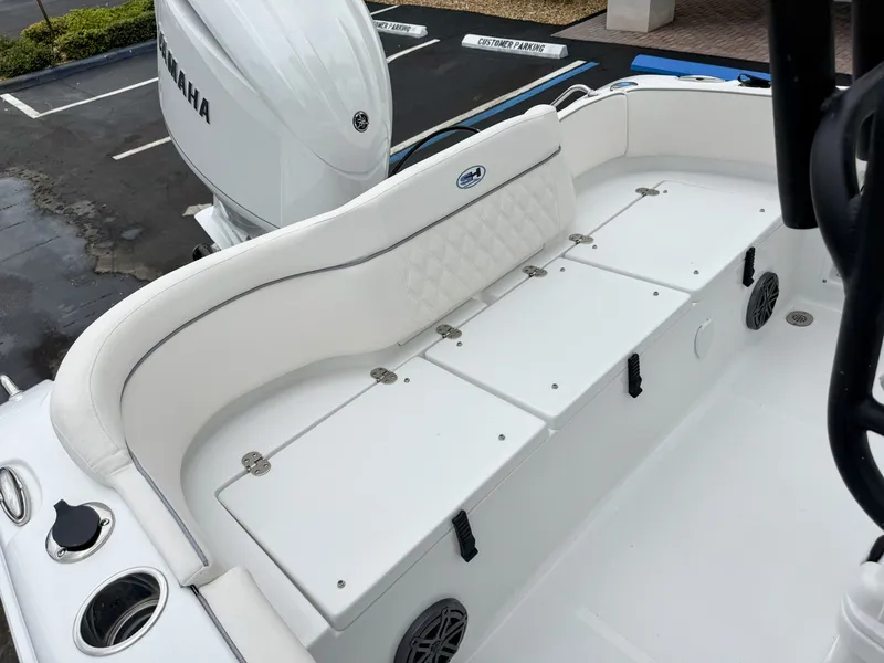 Slide: The Image of The image shows the stern of a Sea Hunt Ultra 219 boat with white upholstery and a Yamaha engine. - 9