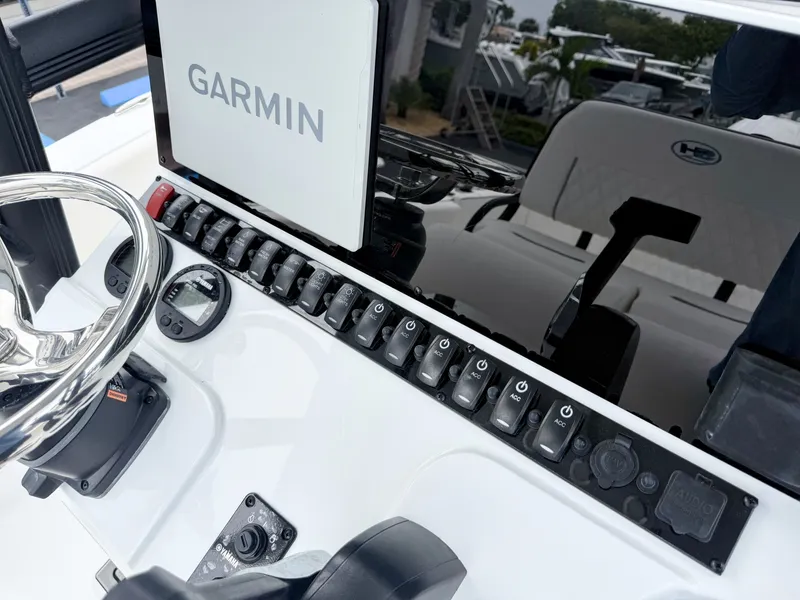 Slide: The Image of The image shows the dashboard of a Sea Hunt Ultra 219 boat with a Garmin screen. - 17