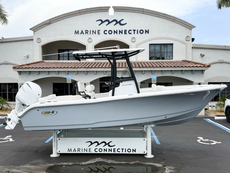 The Image of A 2027 Sea Hunt Ultra 219 boat is displayed in front of a building labeled "Marine Connection." - 1
