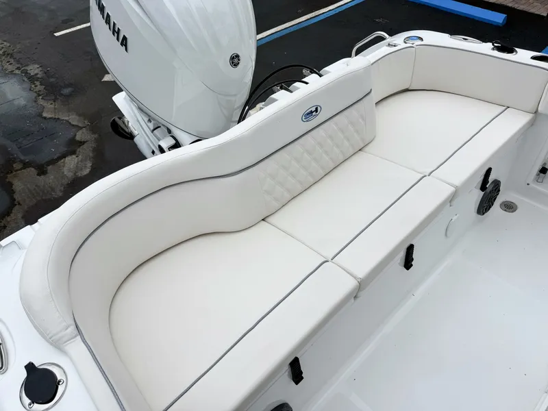 Slide: The Image of The 2027 Sea Hunt Ultra 219 features an elegant white bench seat with a Yamaha engine in the background. - 10