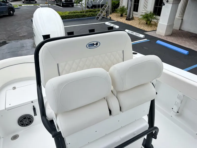 Slide: The Image of The 2027 Sea Hunt Ultra 219 features a cushioned bench seat with white leather and a logo. - 14