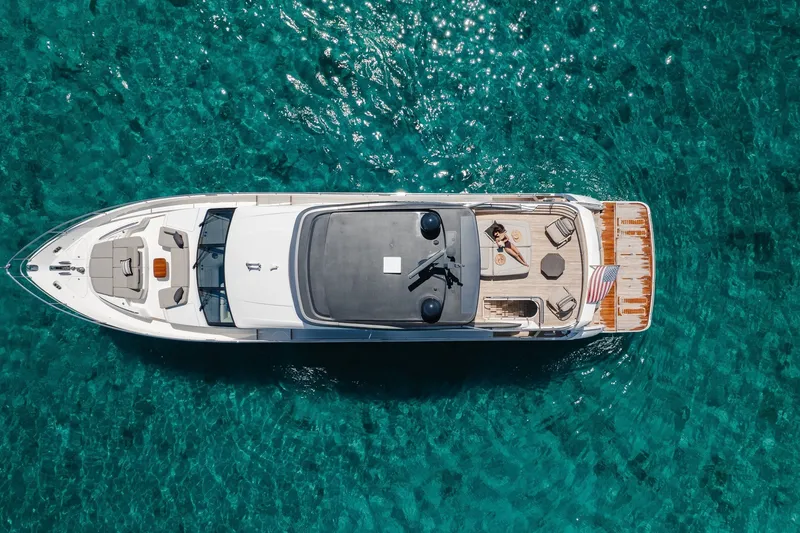 Slide: The Image of Aerial view of 2022 Princess Y78 yacht on clear turquoise water. - 39