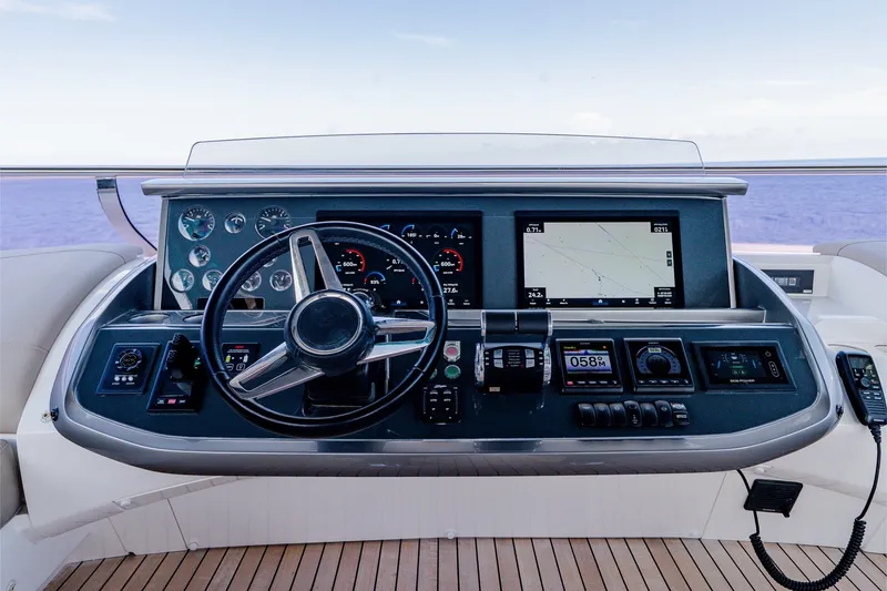 Slide: The Image of Steering console of 2022 Princess Y78 yacht with navigation screens and controls. - 34