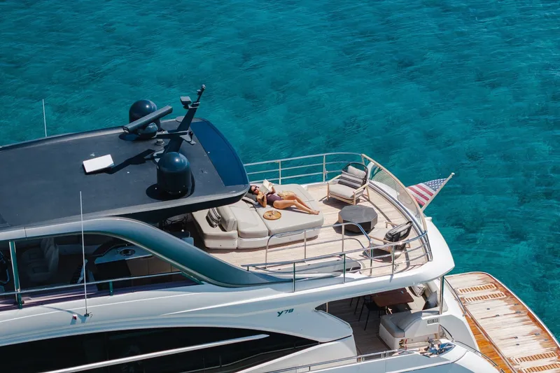 Slide: The Image of Luxurious 2022 Princess Y78 yacht on clear blue water, featuring a sunbathing deck. - 31