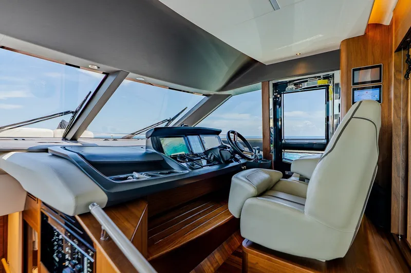 Slide: The Image of Luxurious 2022 Princess Y78 yacht helm with modern controls and panoramic windows. - 16