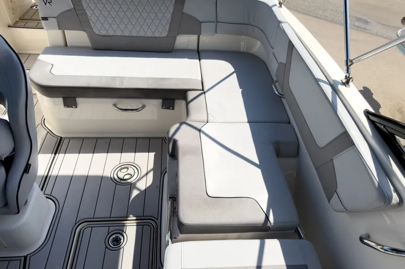 Slide: The Image of 2023 Bayliner VR5 Bowrider OB interior with cushioned seating and sleek design. - 22