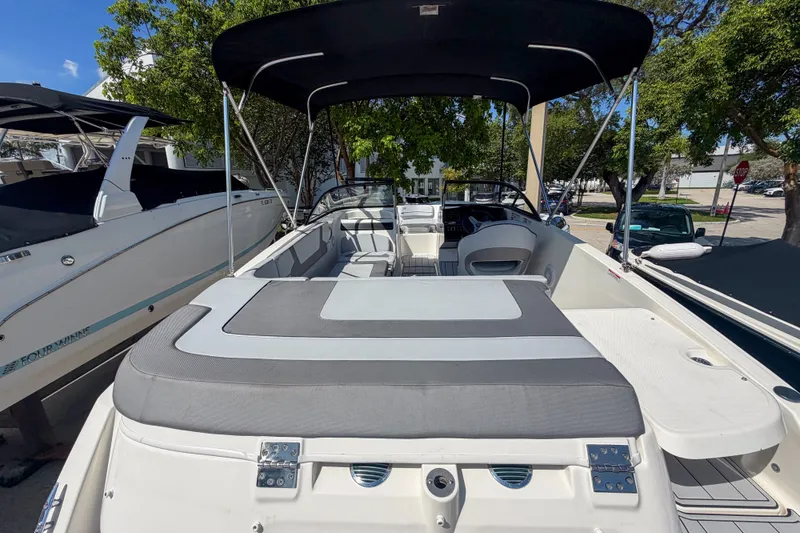 Slide: The Image of 2023 Bayliner VR5 Bowrider OB with canopy, docked outdoors. - 25