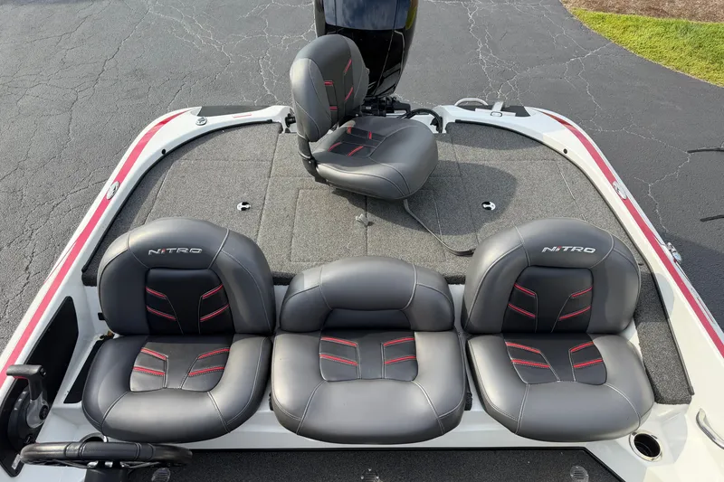 Slide: The Image of 2016 Nitro Z18 boat interior with black and red cushioned seats. - 10