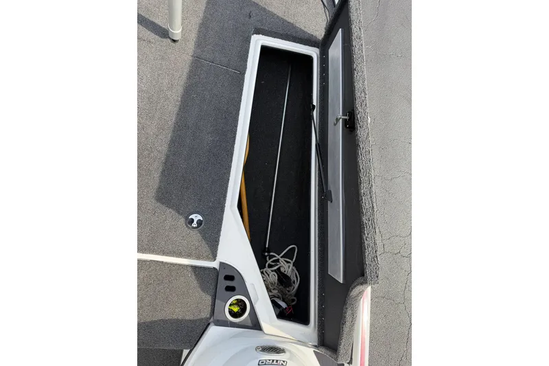 Slide: The Image of Open storage compartment on a 2016 Nitro Z18 boat, showing interior space and equipment. - 21
