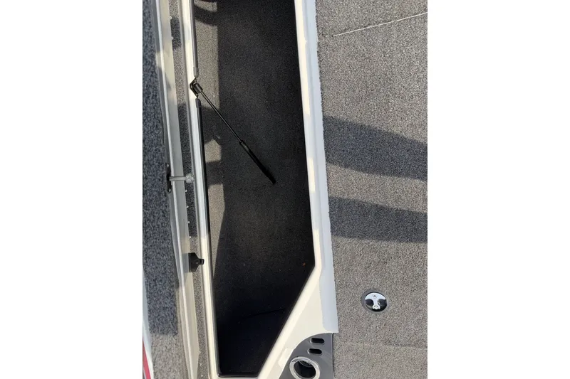 Slide: The Image of Open storage compartment in 2016 Nitro Z18 boat with carpeted interior. - 19