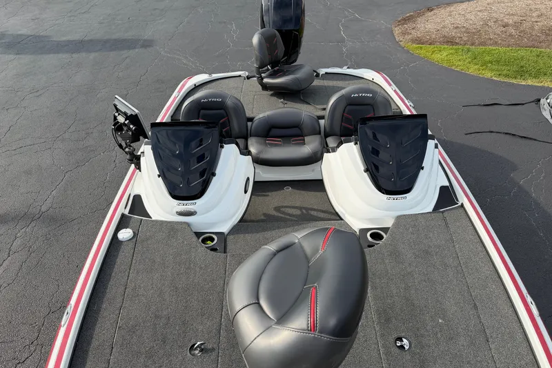 Slide: The Image of 2016 Nitro Z18 boat with dual consoles and seating on a paved surface. - 4