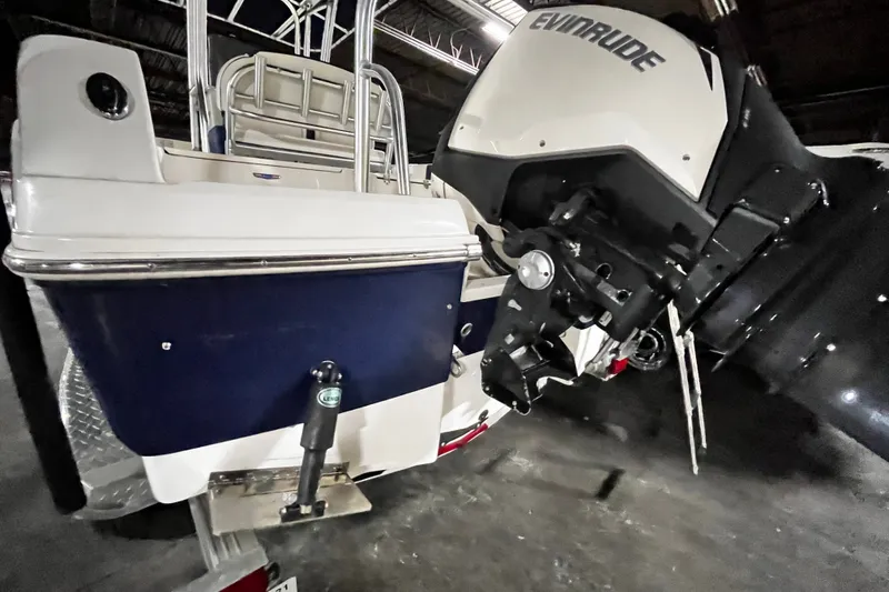 Slide: The Image of 2020 Robalo R200 Center Console boat with Evinrude outboard motor in a garage. - 23