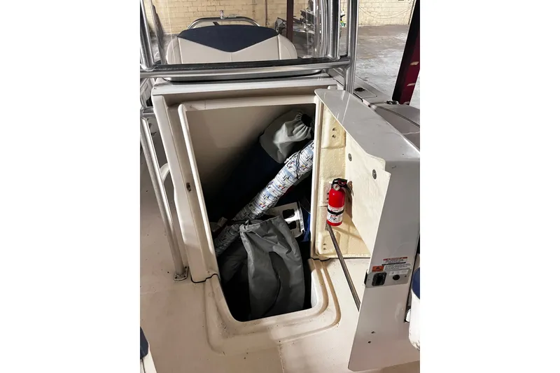 Slide: The Image of 2020 Robalo R200 Center Console storage compartment with fire extinguisher and equipment. - 5