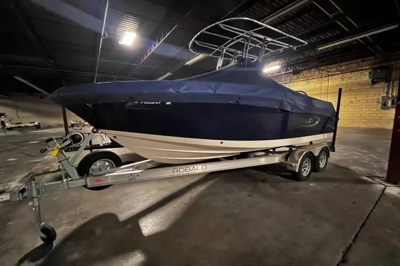 Slide: The Image of 2020 Robalo R200 Center Console boat on trailer in indoor storage. - 2