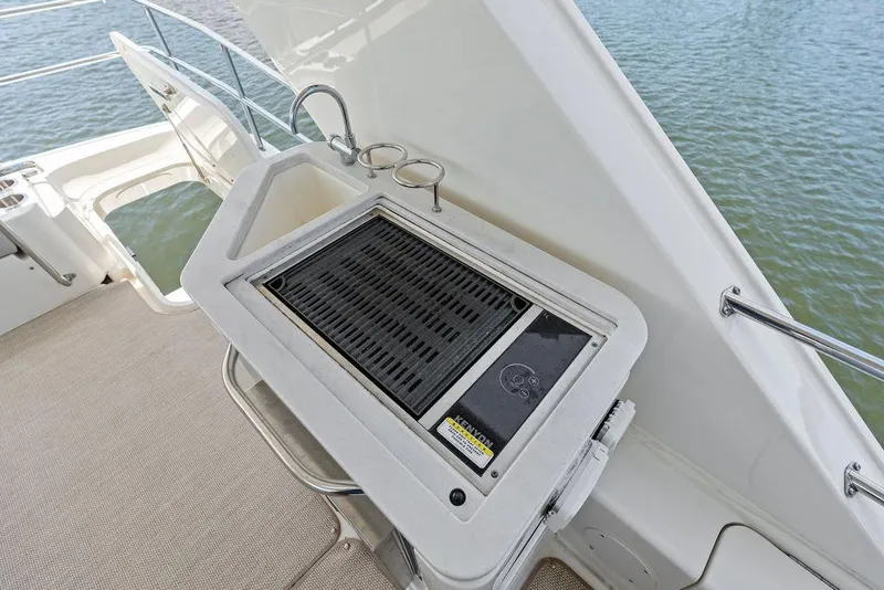 Slide: The Image of A grill on the deck of a 2018 Sea Ray Fly 460, overlooking the water. - 45