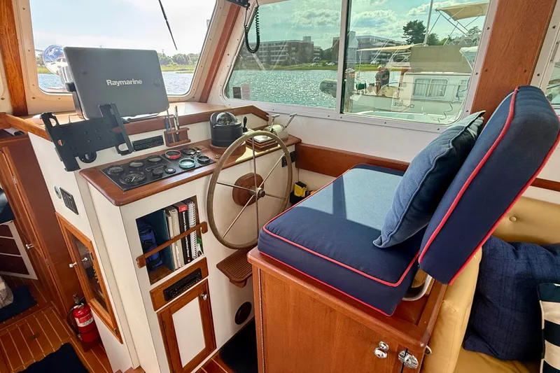 Slide: The Image of 1987 Wilbur Flybridge Cruiser helm with navigation equipment and comfortable seating. - 42